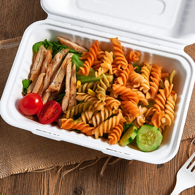 FCS963W sugarcane clamshell take out food container filled with pasta – compostable microwave safe eco friendly packaging for restaurants and catering