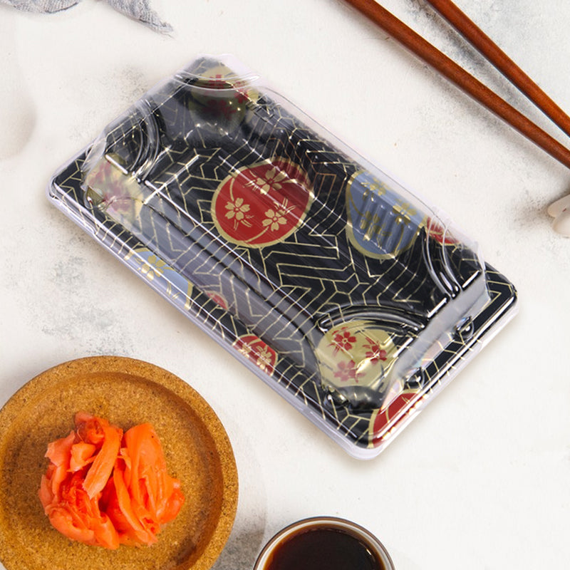03 rectangular black plastic sushi tray container on white table, shown with small dish of kimchi and chopsticks, disposable sushi tray for meals
