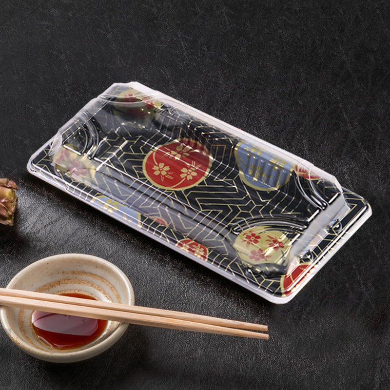 08 rectangular black plastic sushi tray container on black table, shown with sauce dish and chopsticks, disposable sushi serving tray