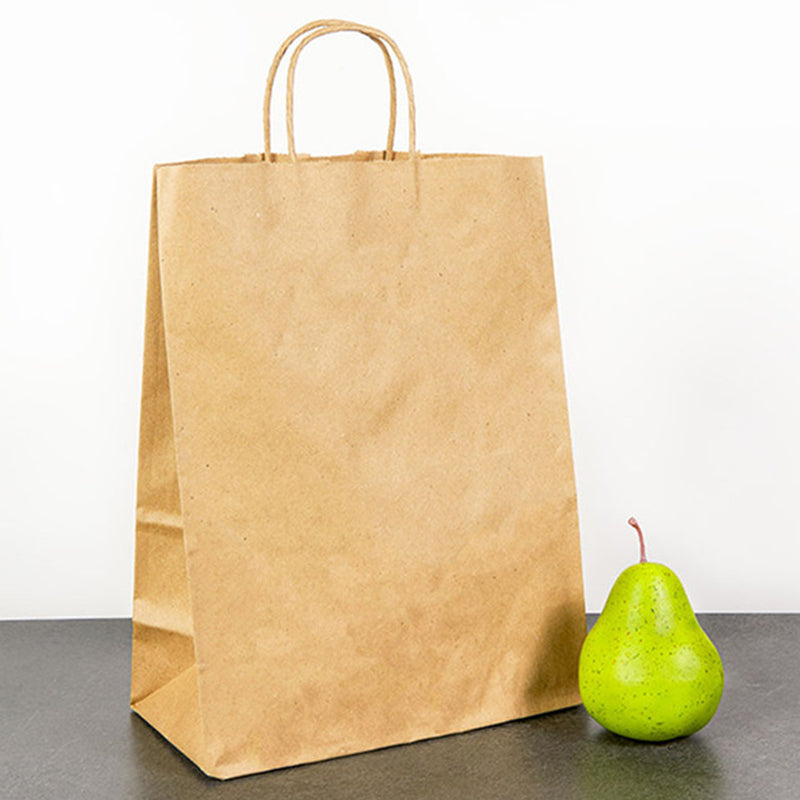 PHB13717 large kraft brown paper bags with handles placed on a table beside fruits – sturdy eco friendly shopping and grocery bags ideal for cafes, stores, and markets