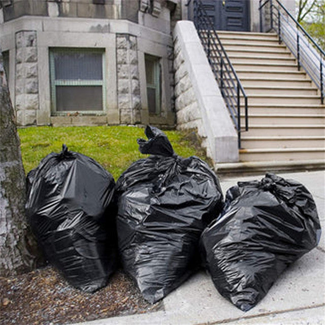 Three full 58 gallon garbage bags placed under tree outdoors – large capacity trash liners for garden waste, lawn cleanup, and commercial outdoor use