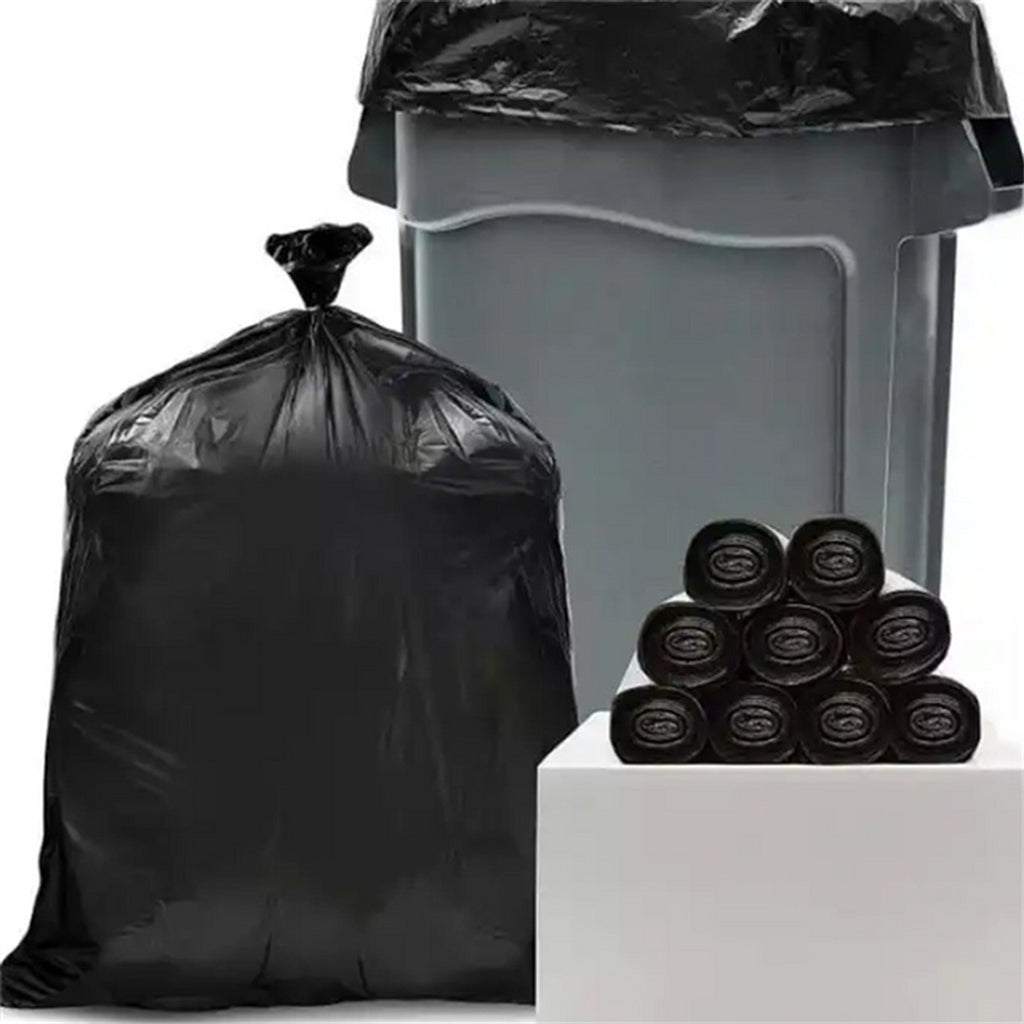 58 gallon garbage bags filled with waste next to garbage bin and rolls – heavy duty commercial black trash bags for home, kitchen, and janitorial use