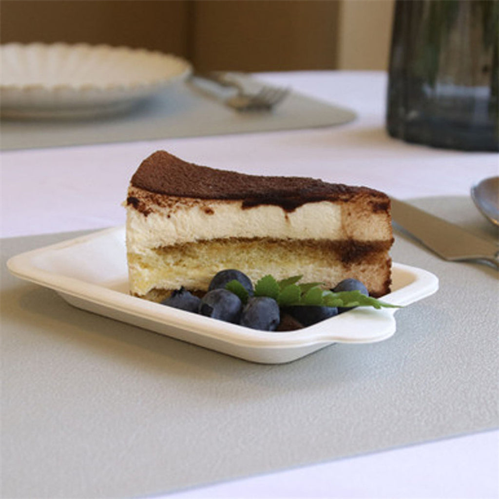 Disposable fiber cake tray in natural white holding blueberry and cake, eco friendly serving tray