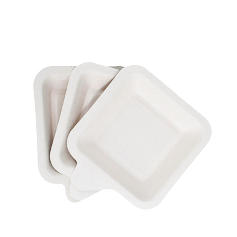 Disposable fiber cake trays in natural white, three trays stacked together